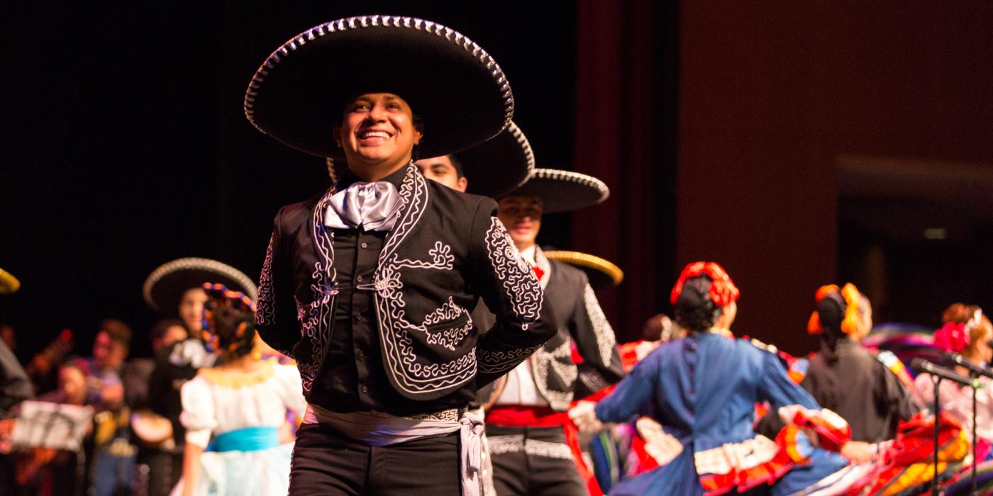 Male folklórico dancer smiling during performance