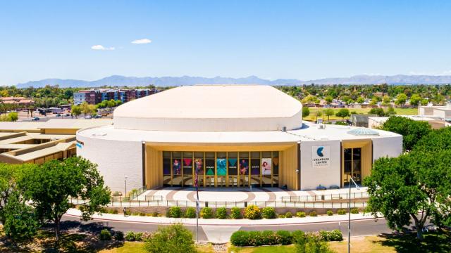 Aerial view of the front of a performing arts center with a blue sky in the background