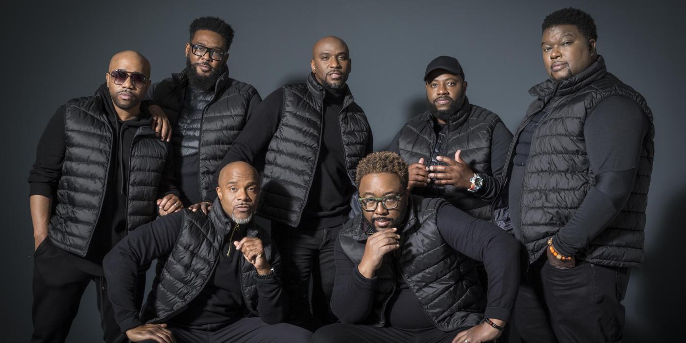 the band Naturally 7 - seven men all dressed in black