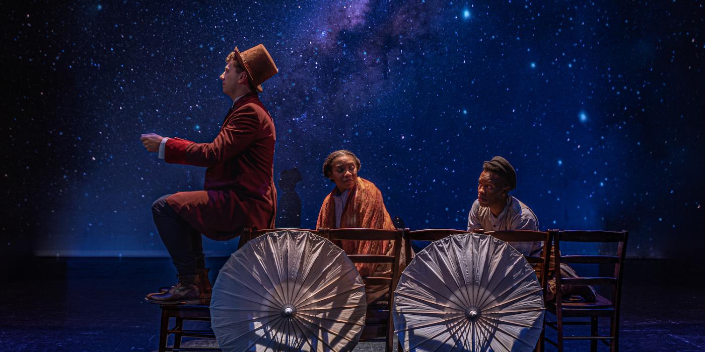 Three people sit in an imaginary wagon, umbrellas for wheels, with a starry night background